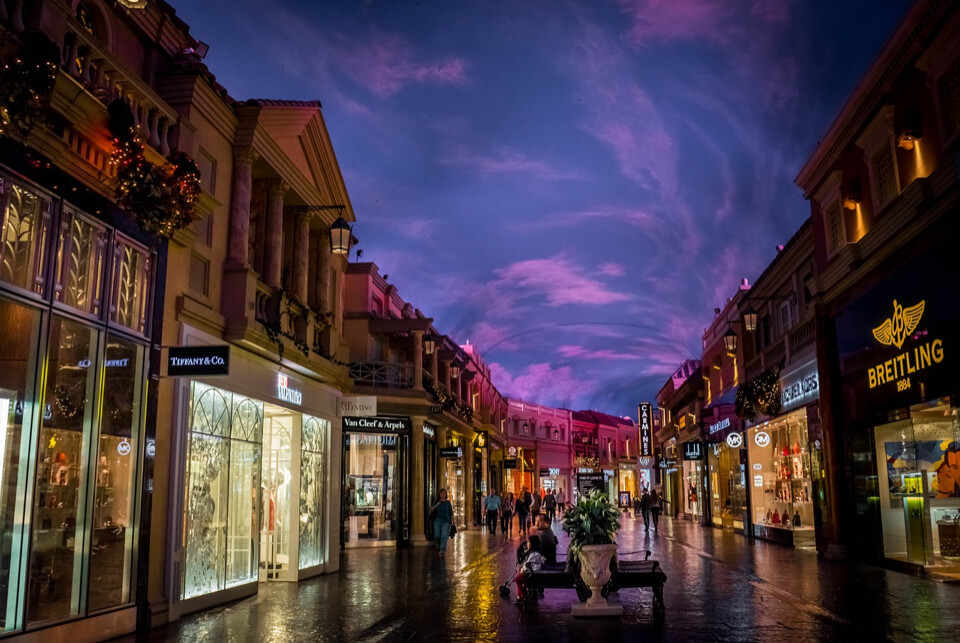 Luxury shopping street lit up late at night.