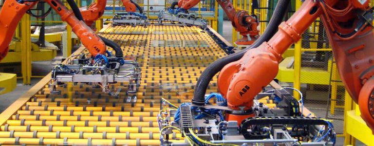 Machines working along factory line.