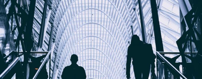 Two people looking at a glass ceiling.