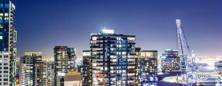 City skyline at night with lights.