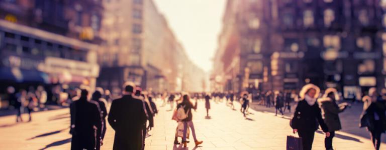 Blurry image of people in street.