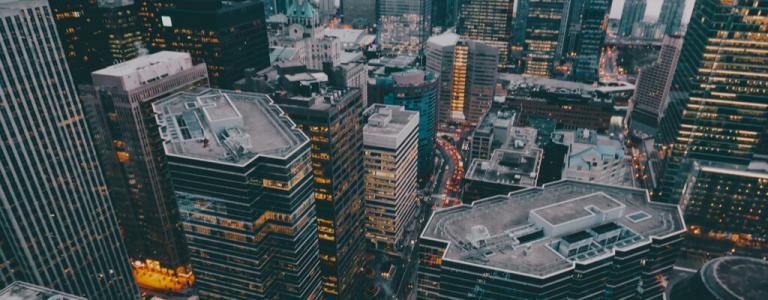 High view of a city at dusk - sky scrapers and orange windows