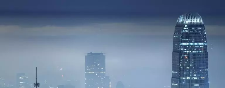 Foggy city skyline at night.