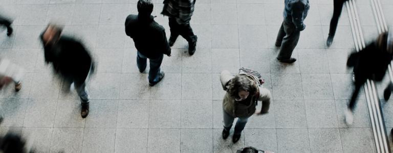 Top down view of people walking in an open area.