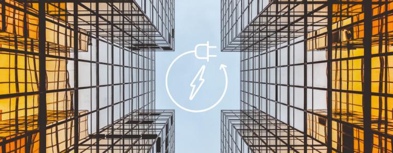 Looking up in-between 2 glass buildings with a power generation icon in the centre