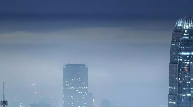 Foggy city skyline at night.